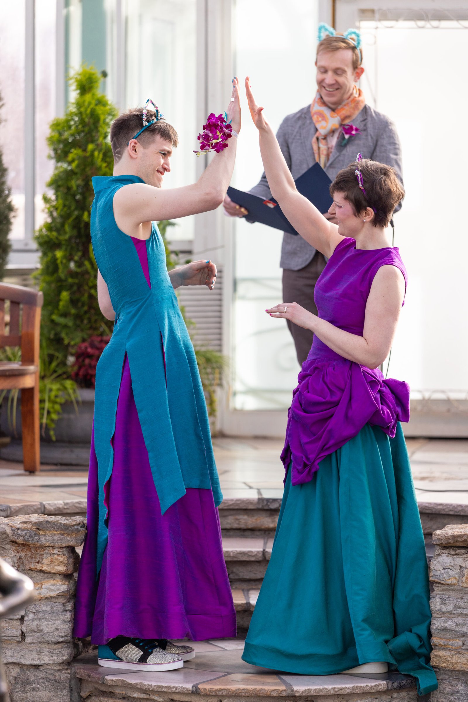 Keira and Shane Sparklecat high-fiving after saying "I do"
